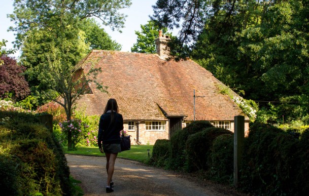 girl returning home to high roofed house